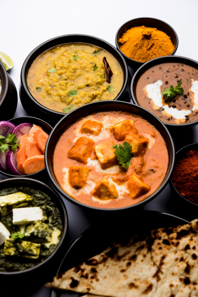 Assorted Indian curries with naan and sides