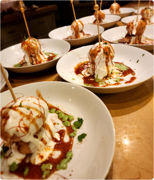 Plates of yogurt-topped Indian chaat bites