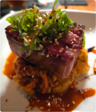 Seared tuna stack topped with seaweed salad